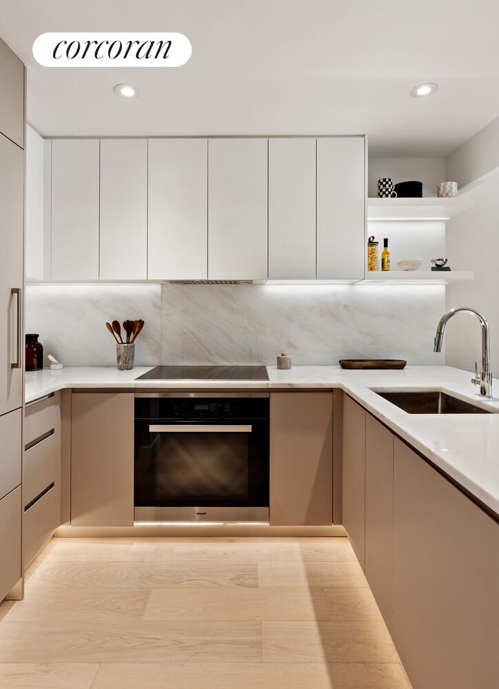 355 West 39th Street, Unit 9A Manhattan, NY 10018 - Photo 2 of 11 a kitchen with a sink cabinets and stainless steel appliances