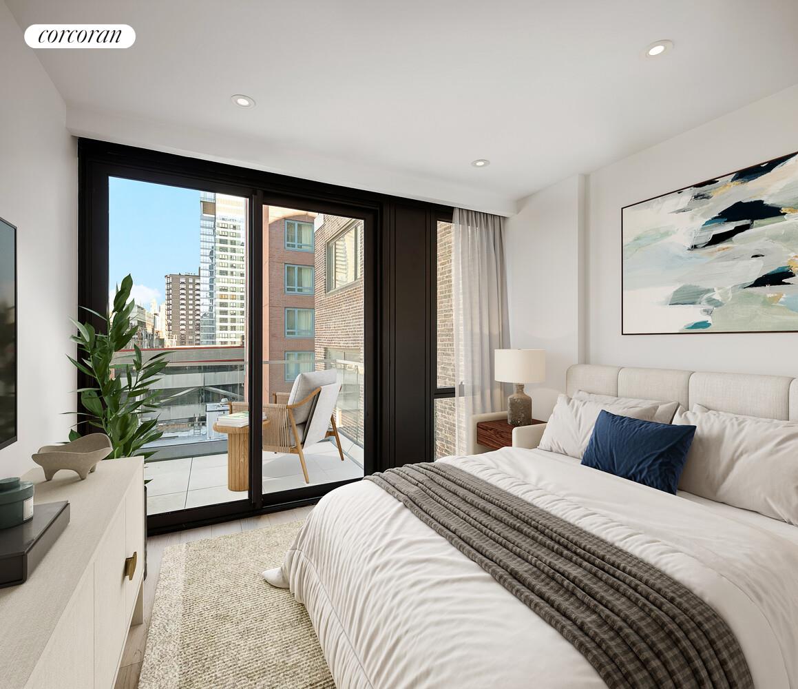 355 West 39th Street, Unit 9A Manhattan, NY 10018 - Photo 5 of 11 a bedroom with a large bed and a large window with outer view