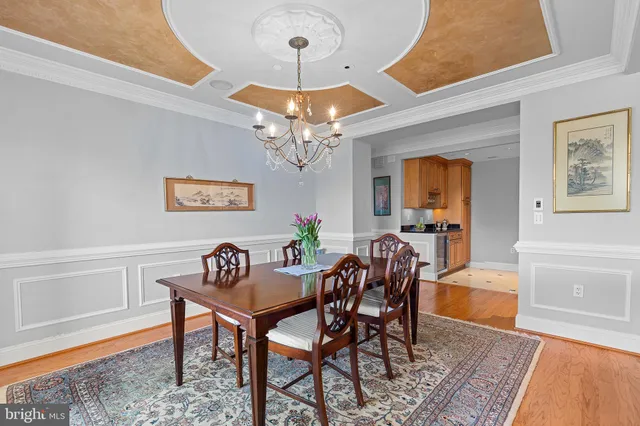 a view of a dining room with furniture and chandelier