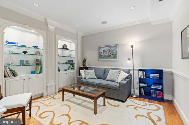 a view of a dining room with furniture a chandelier and wooden floor