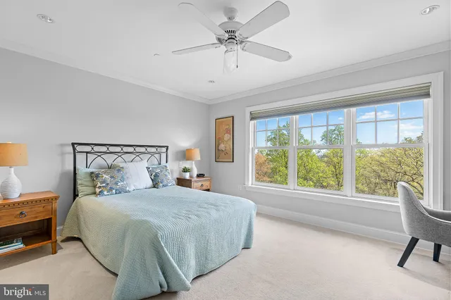 a bedroom with furniture and a large window