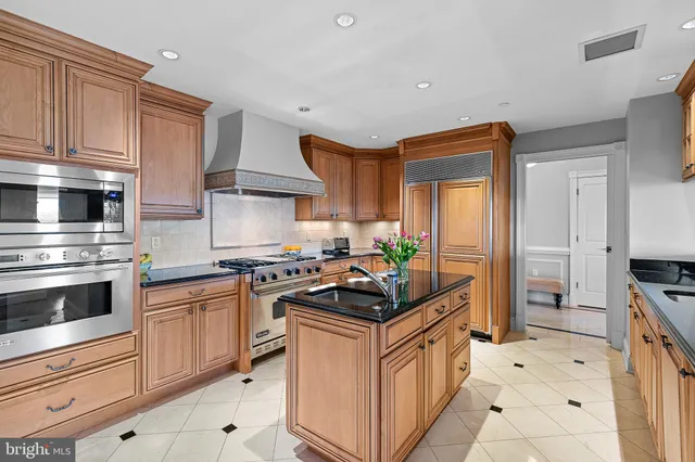 a kitchen with stainless steel appliances a stove sink and cabinets