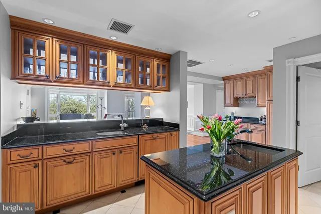 a kitchen with stainless steel appliances granite countertop a sink and a granite counter tops