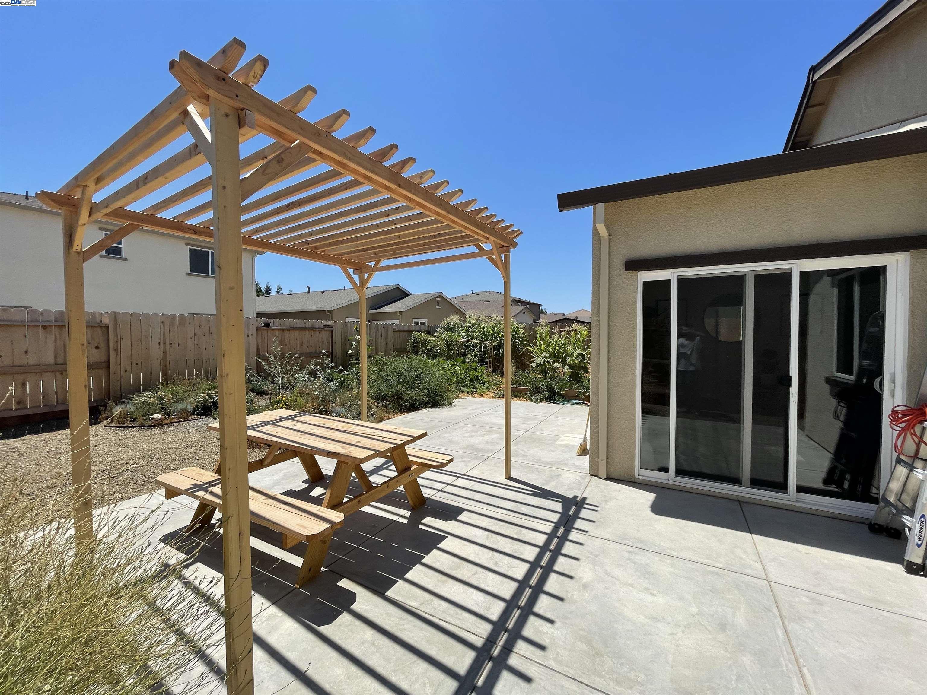 4246 Freemark Avenue Merced, CA 95348 - Photo 12 of 27 a view of patio with a table and chairs under an umbrella