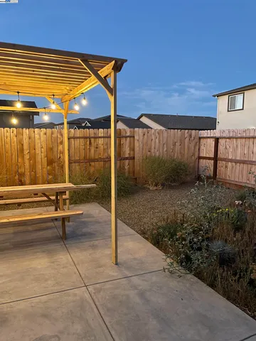 a swimming pool with outdoor seating and yard