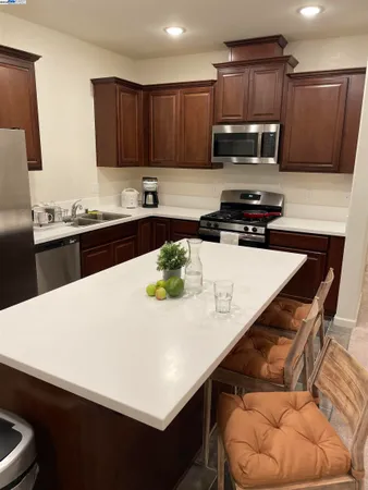a kitchen with a sink a stove and a wooden cabinets