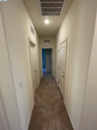 an empty room with closet and natural light