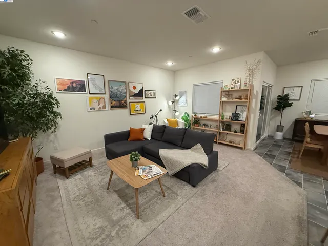 a living room with furniture and a book shelf