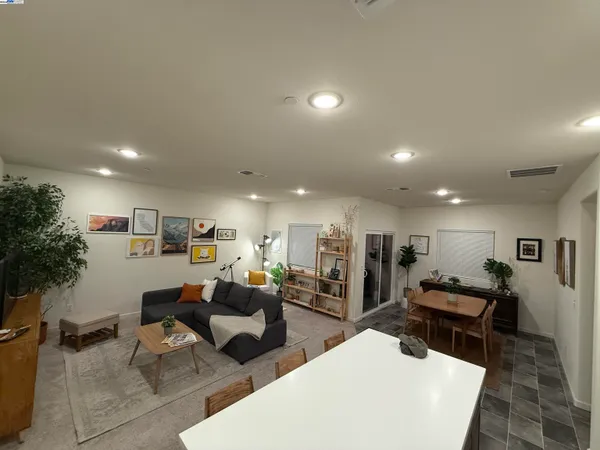 a living room with furniture and kitchen view