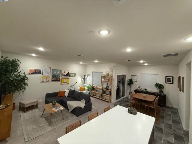 a living room with furniture and kitchen view