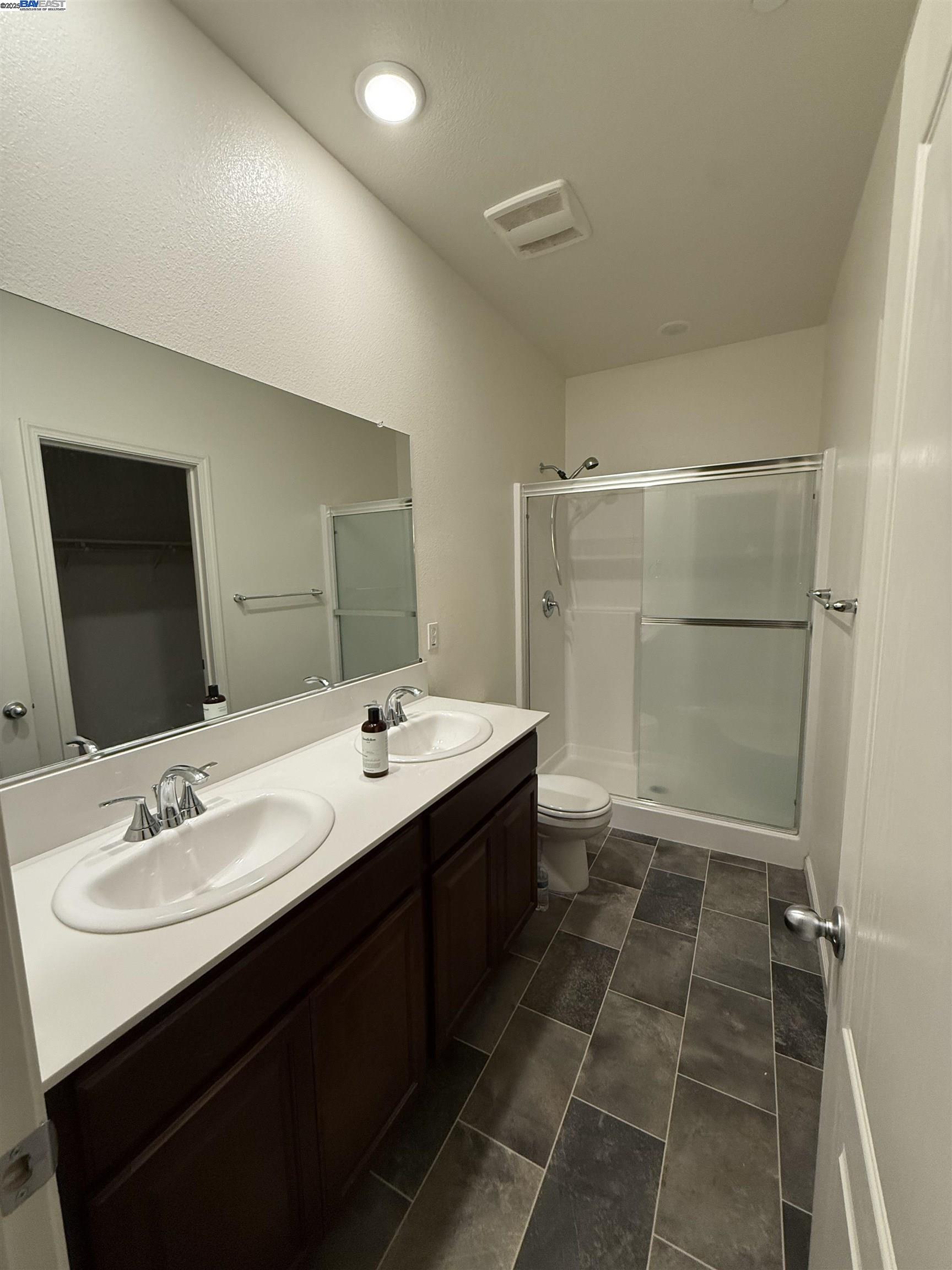 4246 Freemark Avenue Merced, CA 95348 - Photo 9 of 27 a bathroom with a double vanity sink mirror and shower