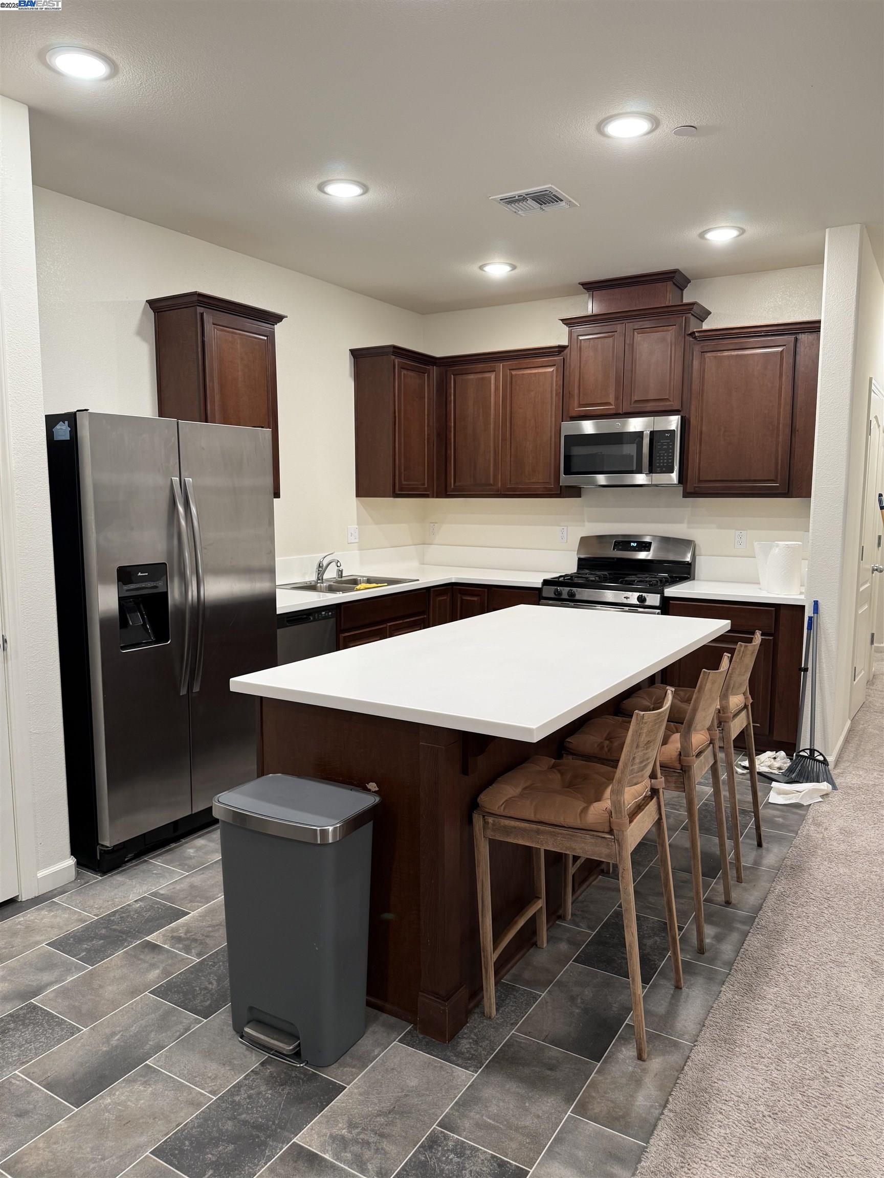 4246 Freemark Avenue Merced, CA 95348 - Photo 10 of 27 a kitchen with stainless steel appliances a microwave a sink and a refrigerator