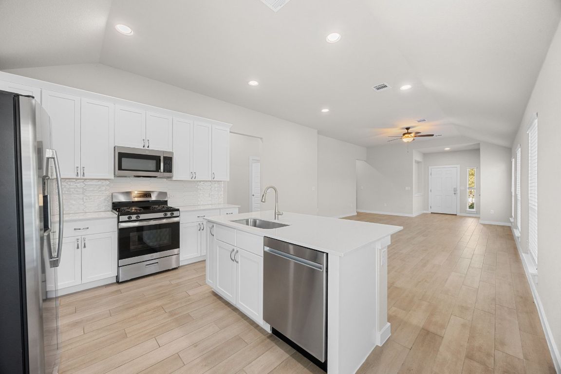 a kitchen with a stove and a microwave