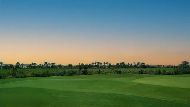 a front view of a house with a yard and potted plants