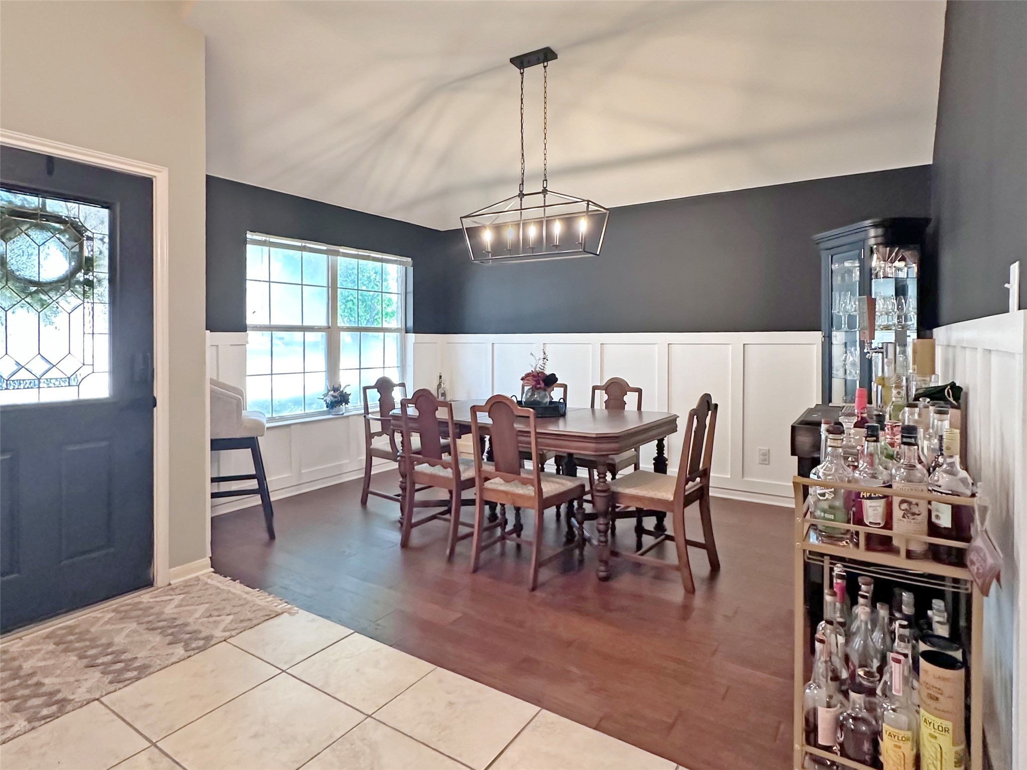 20213 Kearney Hill Road Pflugerville, TX 78660 - Photo 3 of 27 Hardwood flooring extends throughout this dining area, complemented by wainscoting and a vaulted ceiling.