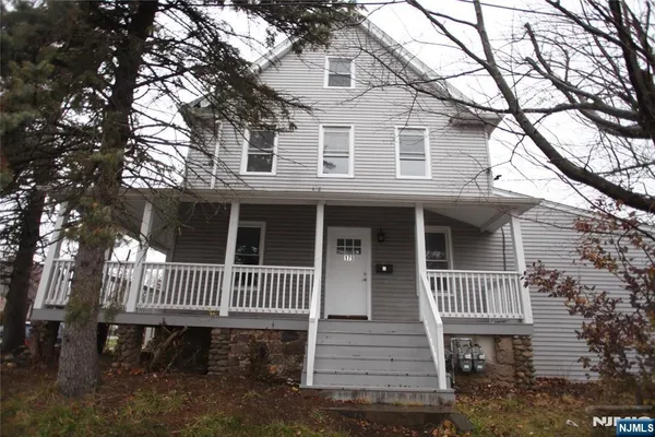 a front view of a house with a deck