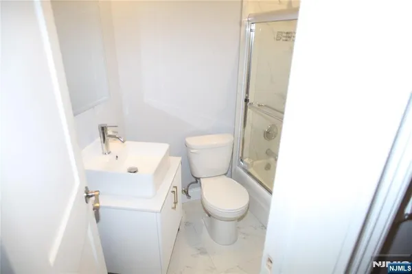 a white toilet sitting next to a bathroom sink