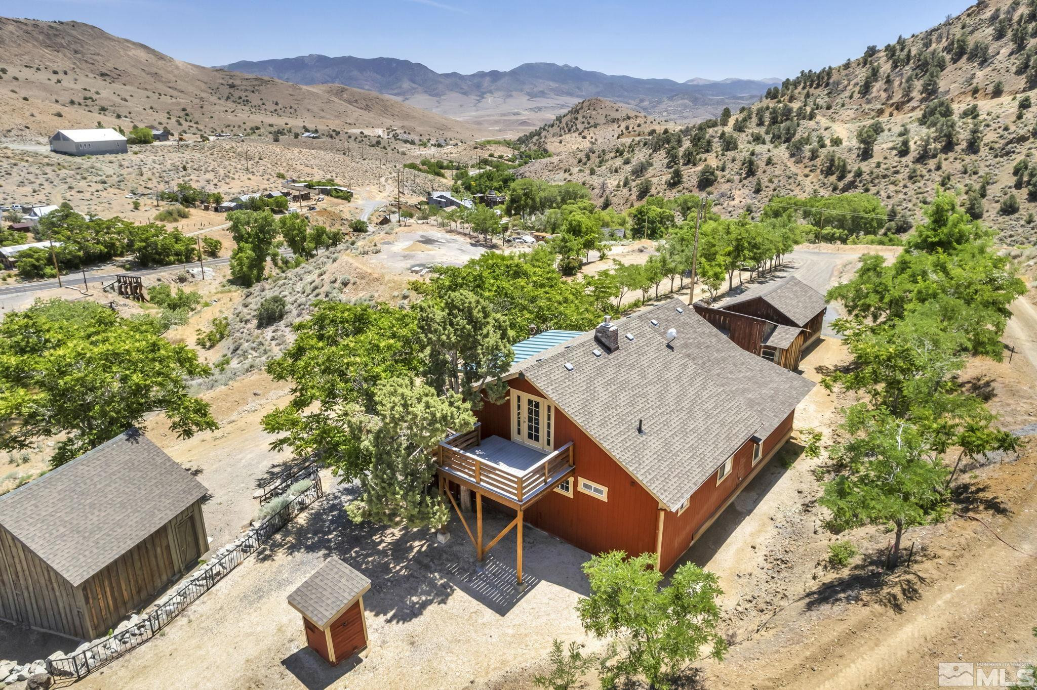 an aerial view of a house with a yard