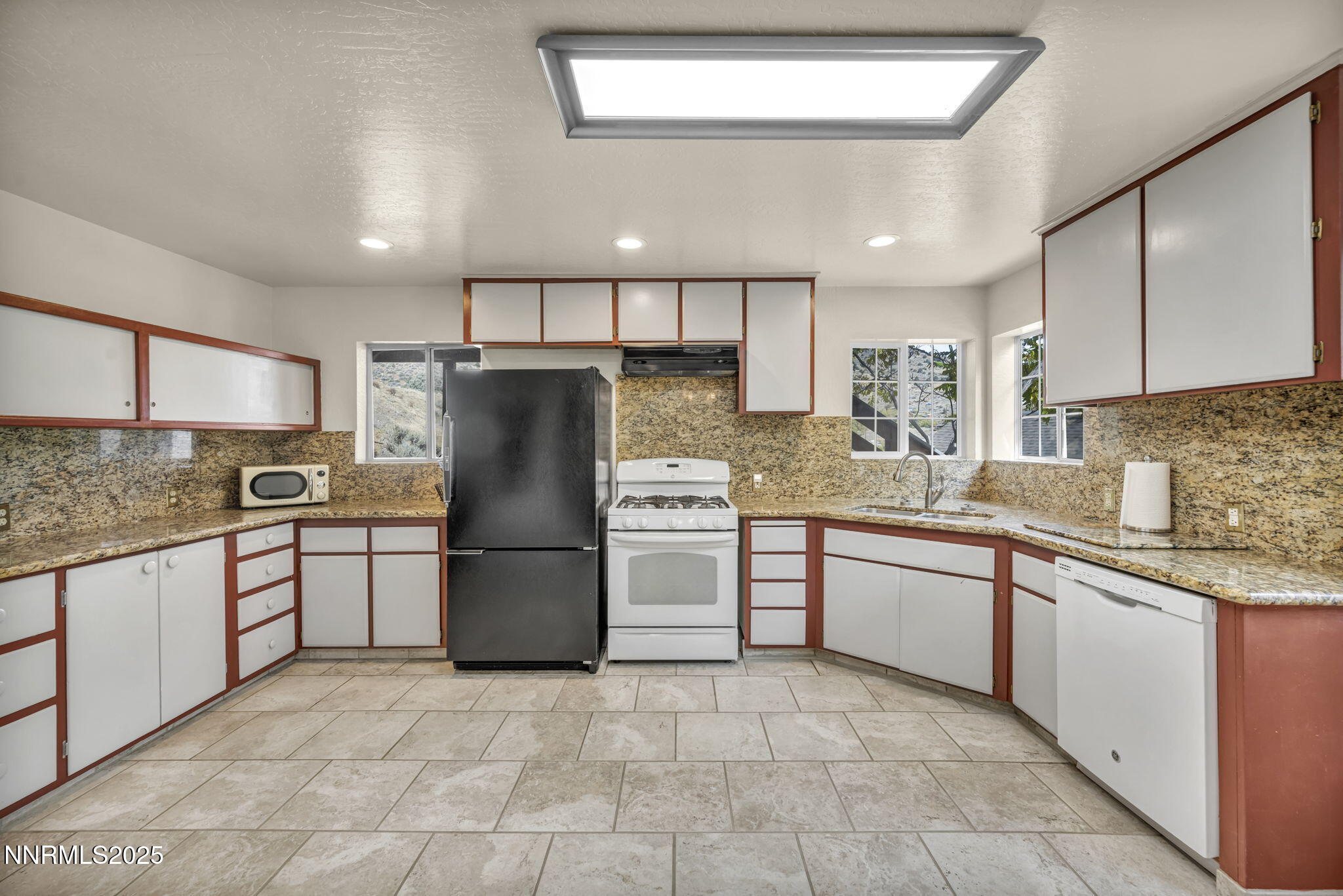 100 Pedlar Road Silver City, NV 89428 - Photo 13 of 65 a kitchen with a refrigerator sink and cabinets