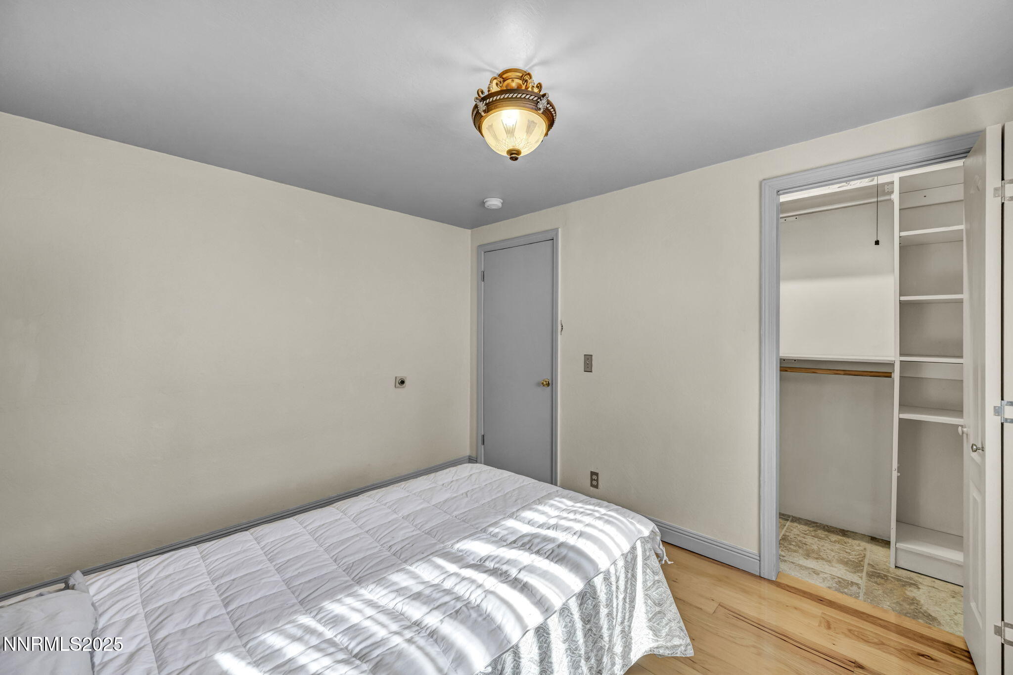 100 Pedlar Road Silver City, NV 89428 - Photo 26 of 65 a bedroom with a bed and a chandelier