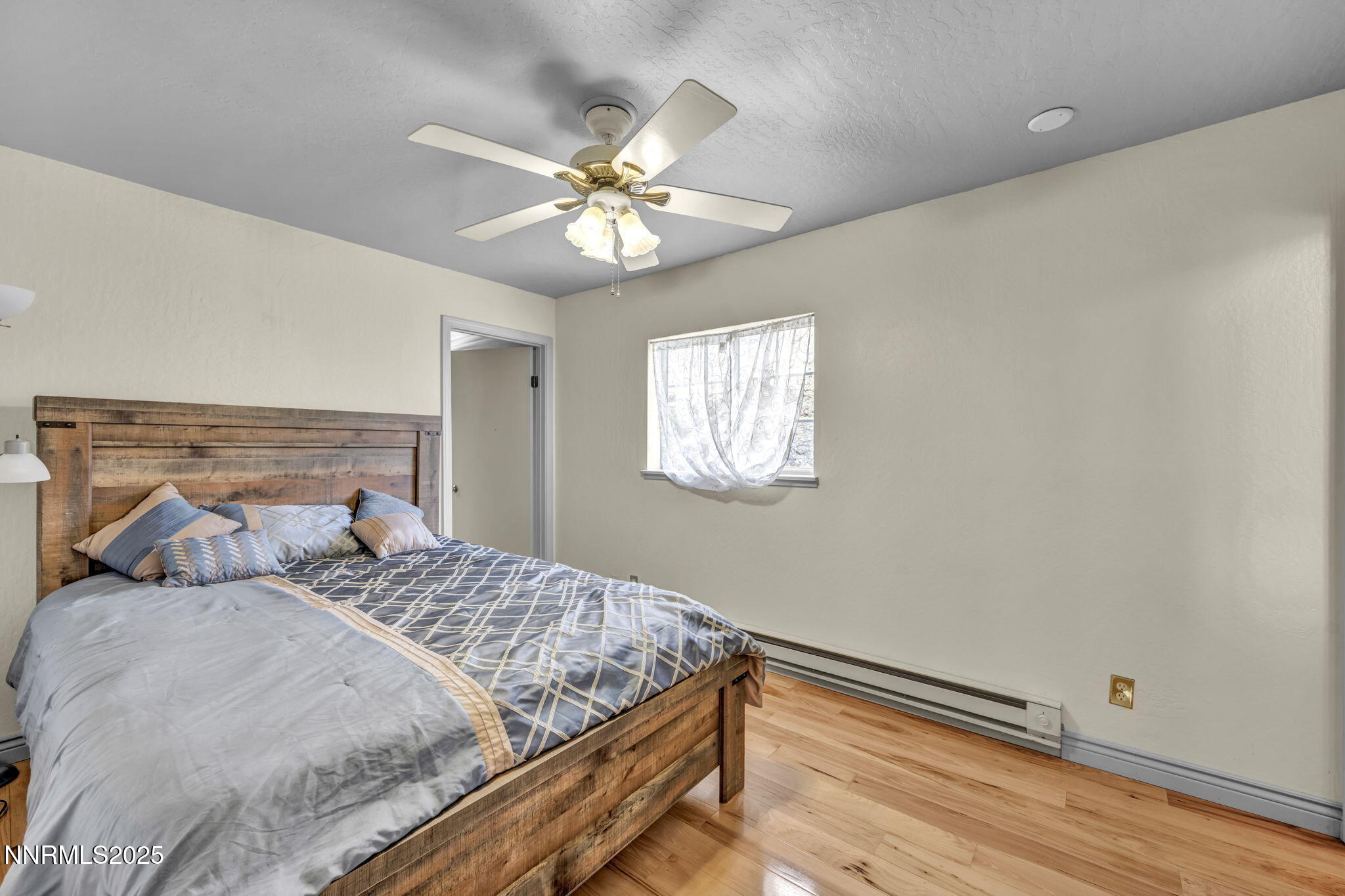 100 Pedlar Road Silver City, NV 89428 - Photo 32 of 65 a bedroom with a bed and a chandelier