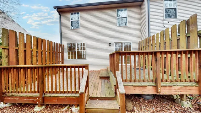 a view of a house with wooden floor roof and wooden fence