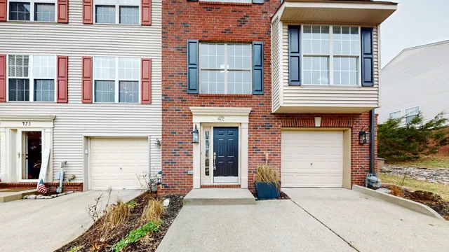 a front view of a house with many windows