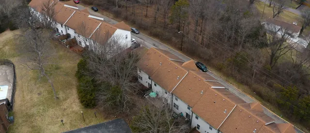 a aerial view of a brick house with many windows
