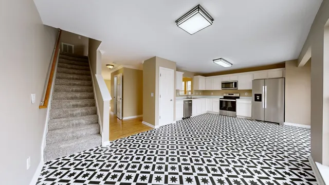 a kitchen with a refrigerator a sink and a window