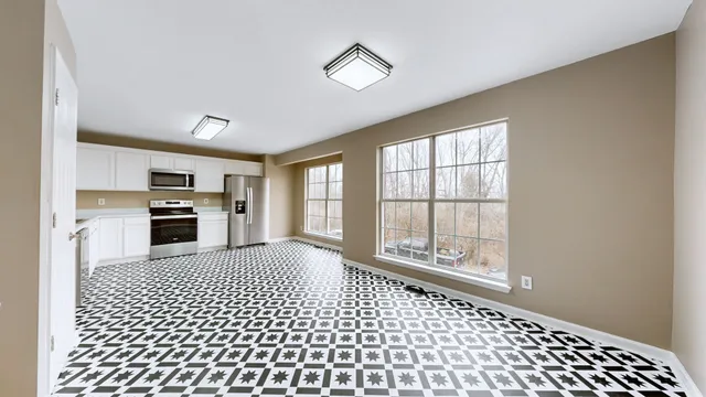 a kitchen with a refrigerator a stove top oven a sink and dishwasher