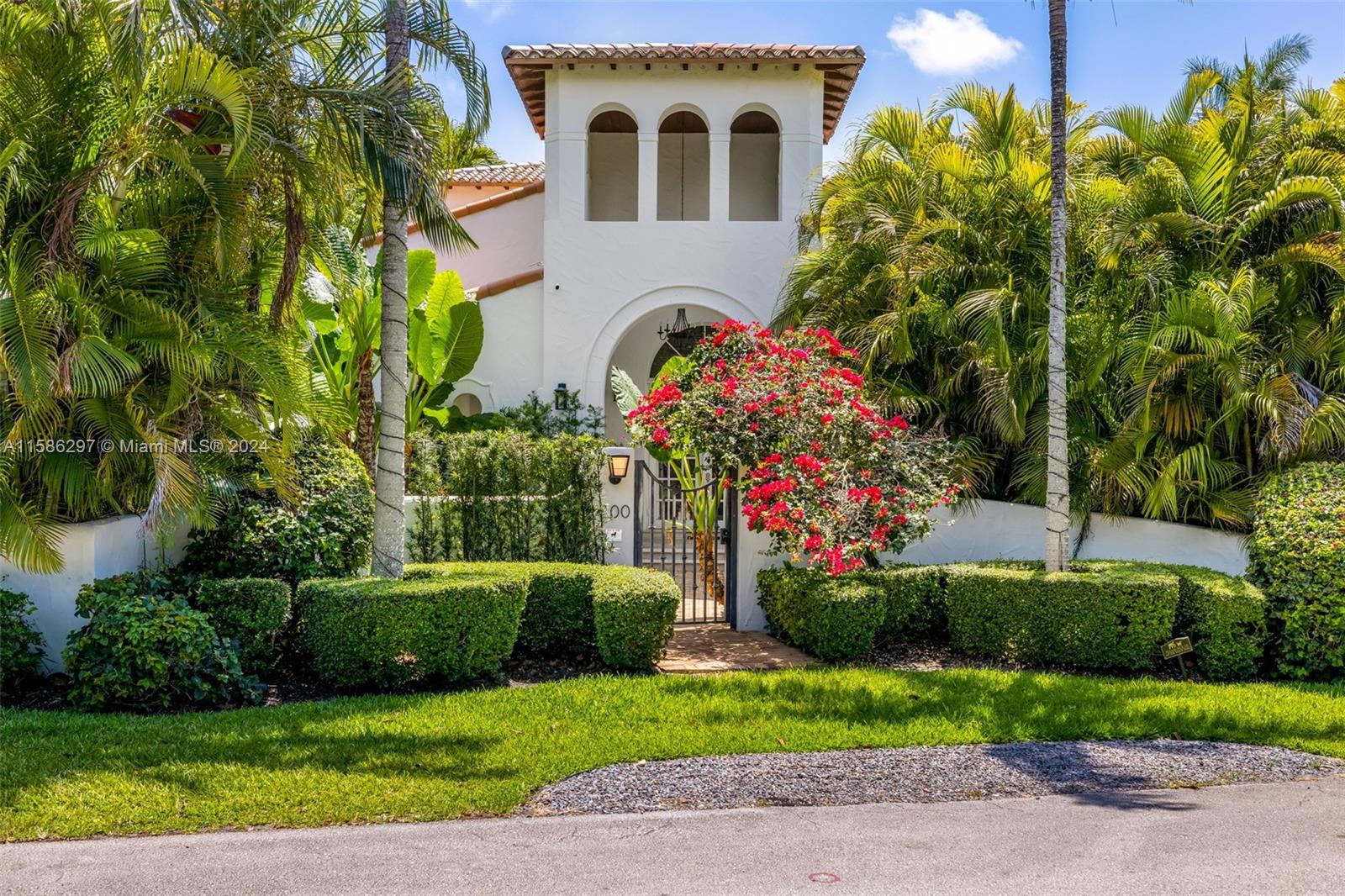 200 Ridgewood Road Coral Gables, FL 33133 - Photo 2 of 70 a front view of a house with a yard and potted plants