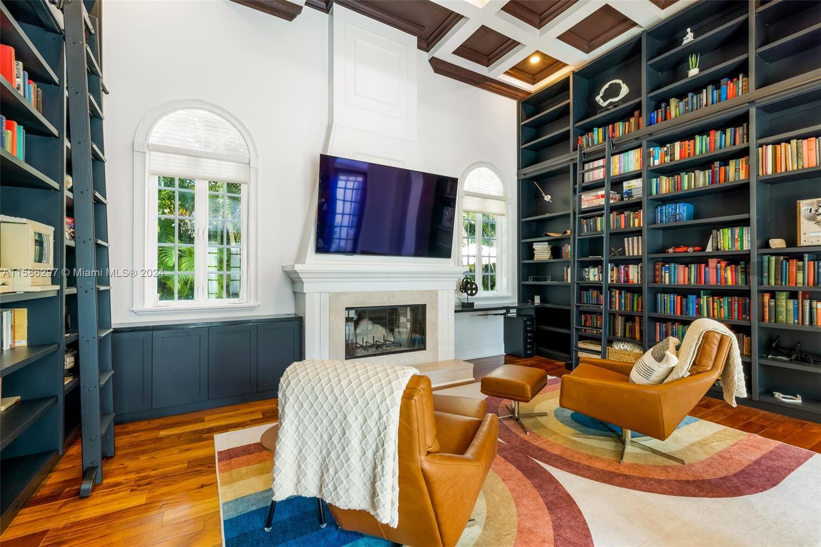 200 Ridgewood Road Coral Gables, FL 33133 - Photo 24 of 70 a living room with fireplace furniture and a book shelf