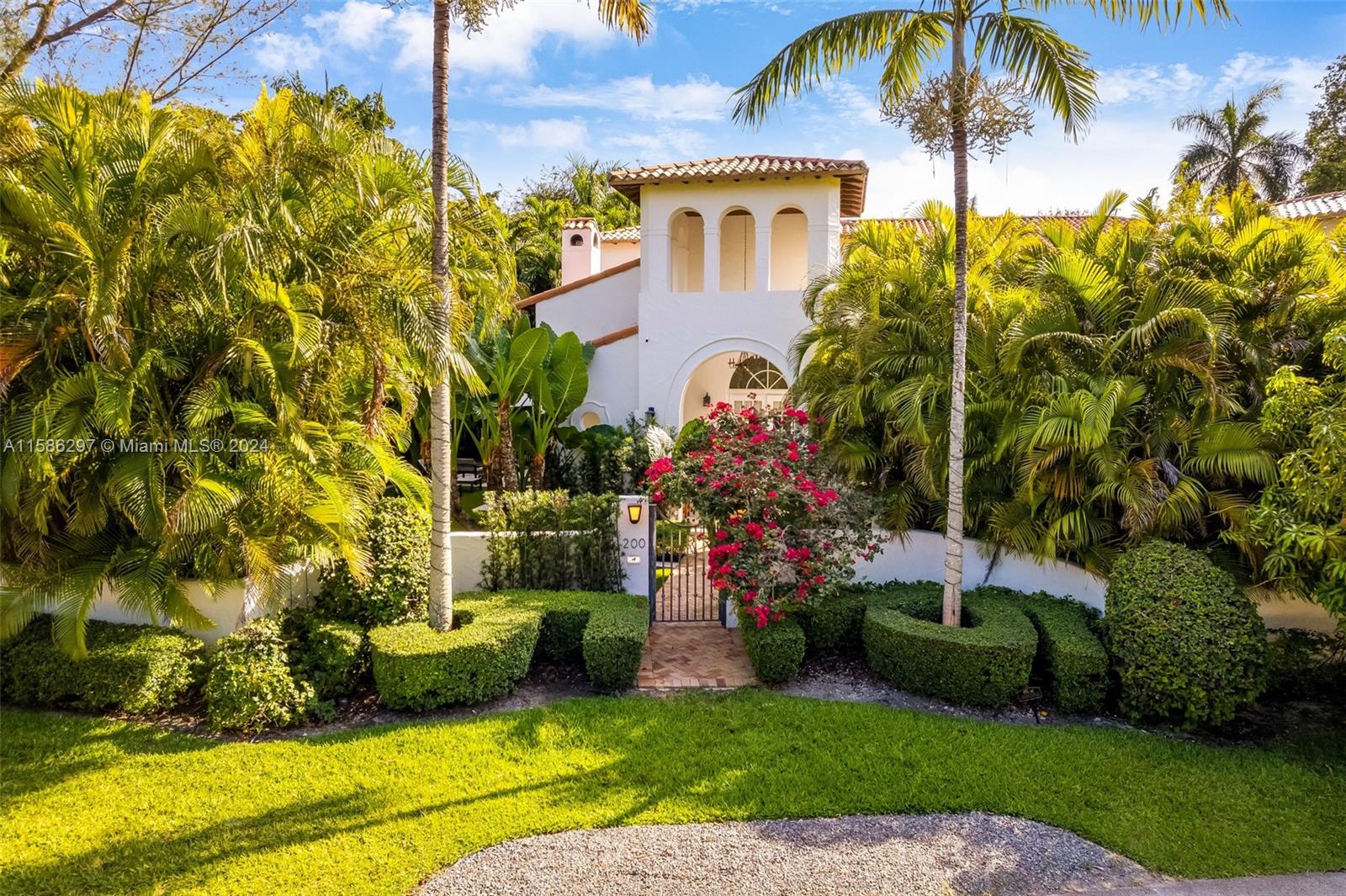 200 Ridgewood Road Coral Gables, FL 33133 - Photo 3 of 70 a front view of a house with a yard and swimming pool