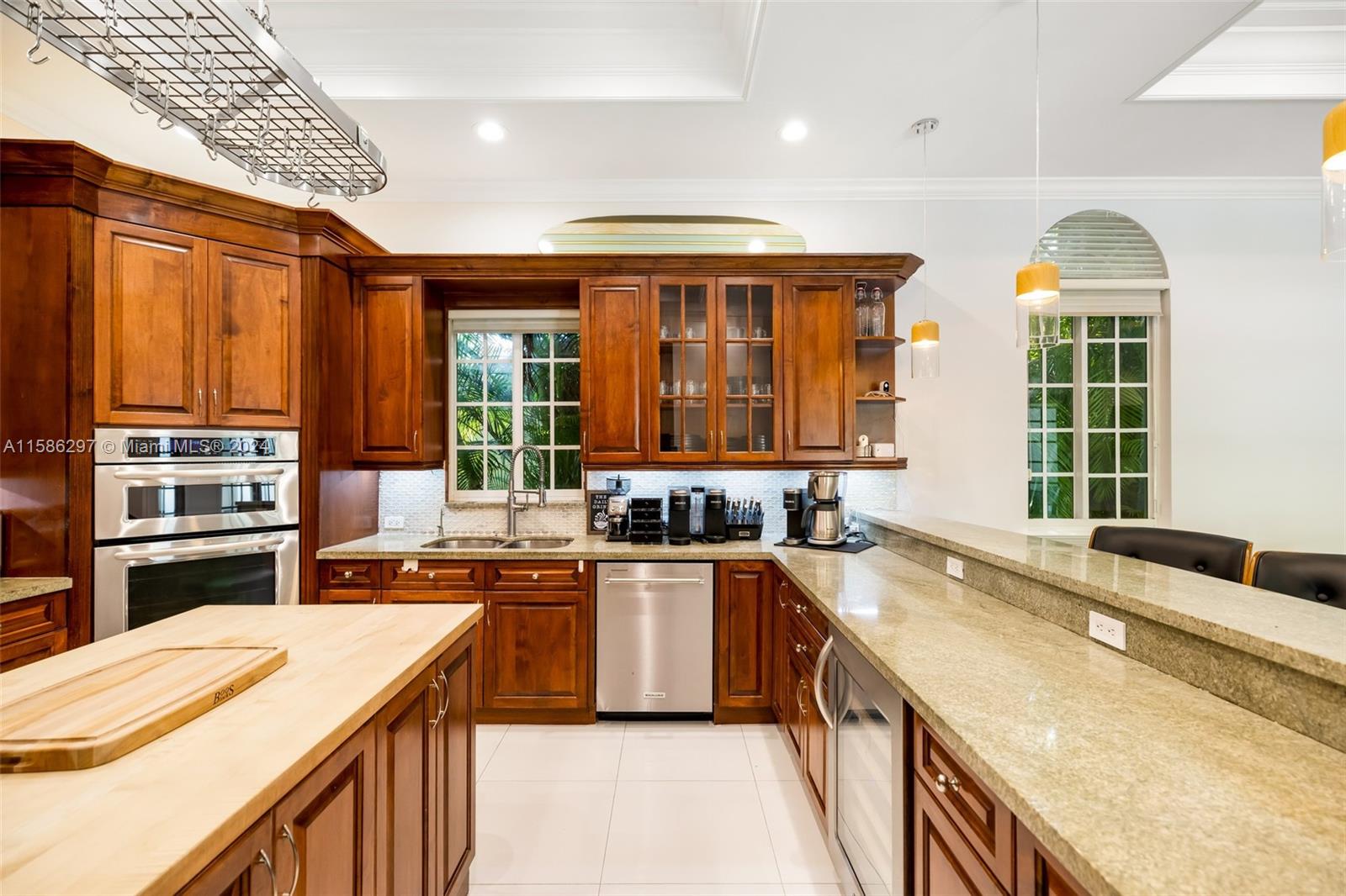 200 Ridgewood Road Coral Gables, FL 33133 - Photo 31 of 70 a kitchen that has a sink and a stove in it