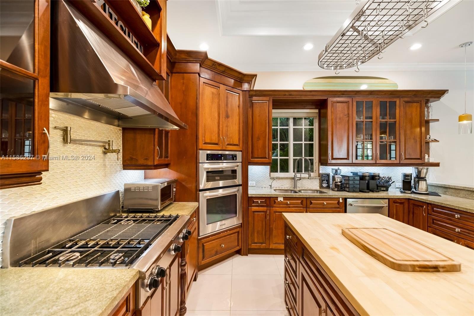 200 Ridgewood Road Coral Gables, FL 33133 - Photo 32 of 70 a kitchen with a stove and a sink