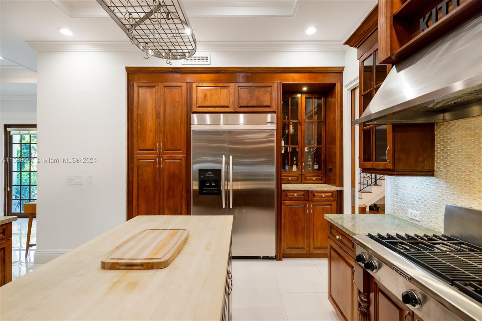 200 Ridgewood Road Coral Gables, FL 33133 - Photo 33 of 70 a kitchen with stainless steel appliances kitchen island granite countertop a stove and a refrigerator