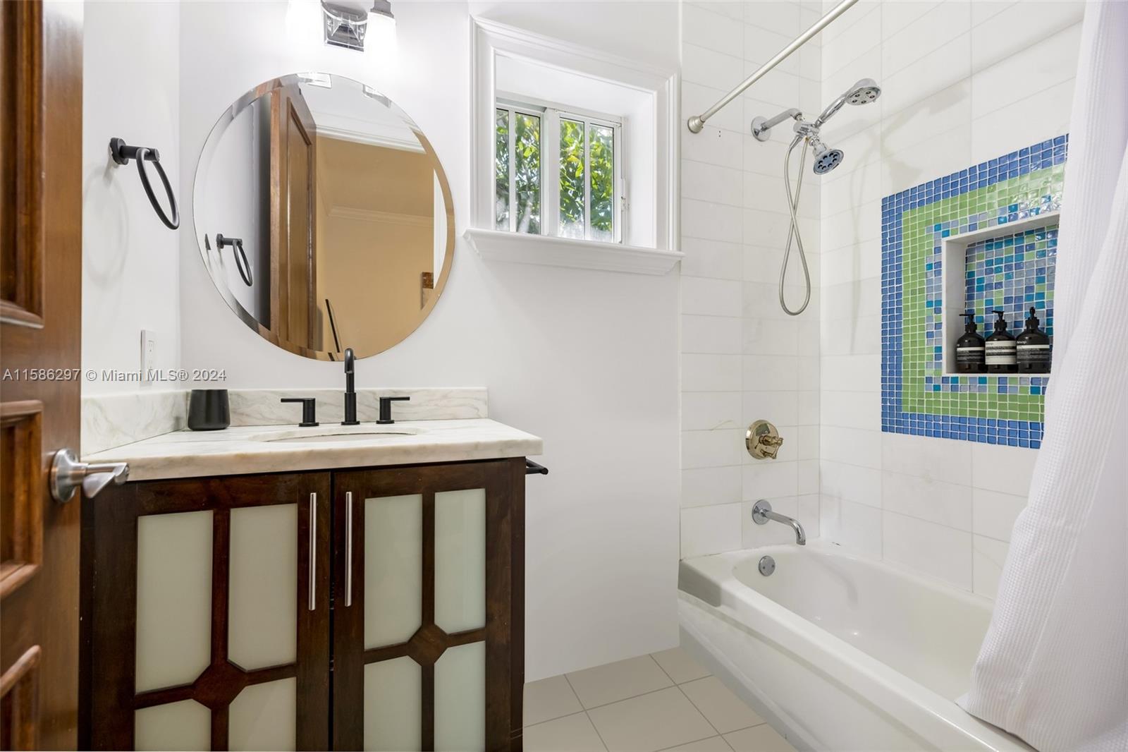 200 Ridgewood Road Coral Gables, FL 33133 - Photo 38 of 70 a bathroom with a tub sink and mirror