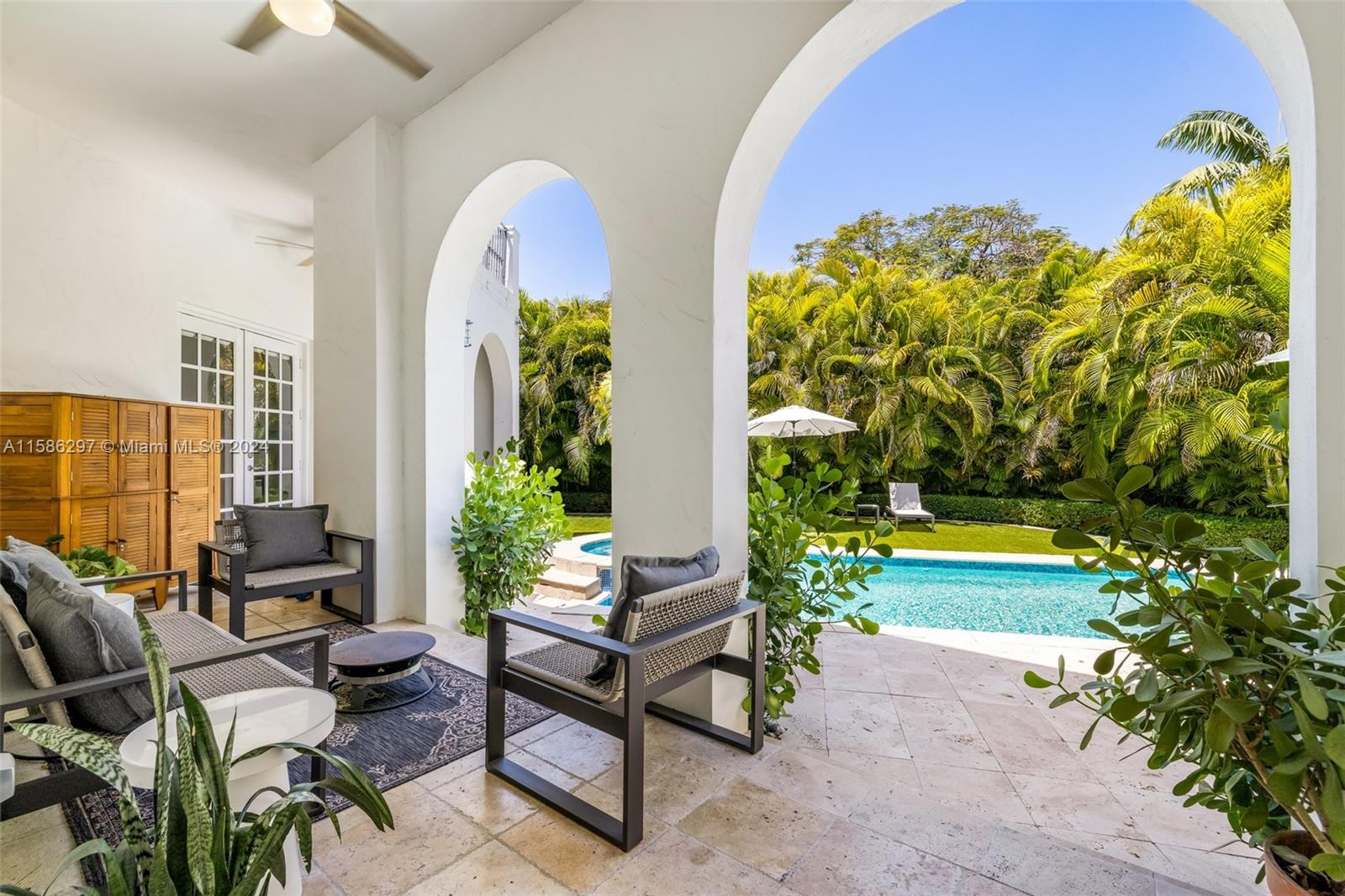 200 Ridgewood Road Coral Gables, FL 33133 - Photo 6 of 70 a swimming pool with outdoor seating and yard