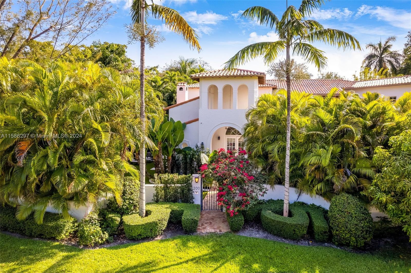 200 Ridgewood Road Coral Gables, FL 33133 - Photo 61 of 70 a front view of a house with a garden