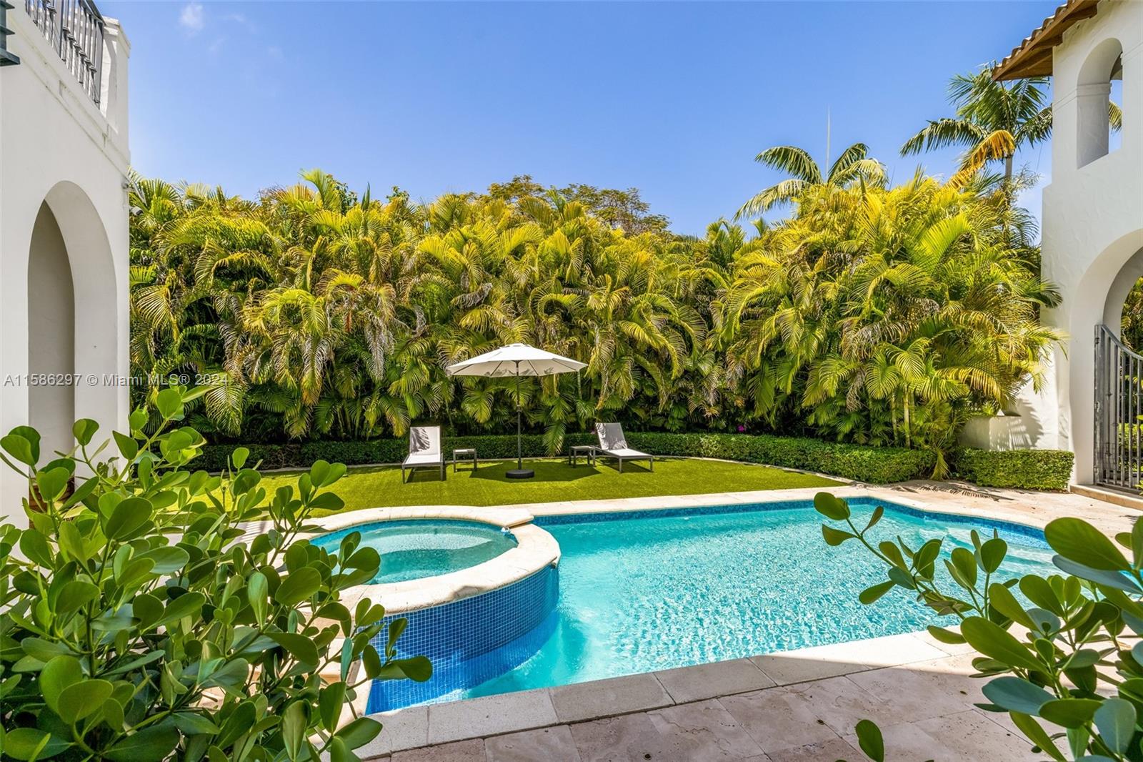 200 Ridgewood Road Coral Gables, FL 33133 - Photo 10 of 70 a view of a swimming pool with a yard