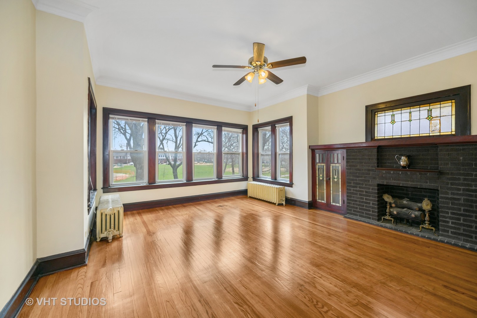 2736 North Harding Avenue, Unit 2 Chicago, IL 60647 - Photo 3 of 12 a view of an empty room with wooden floor and a window