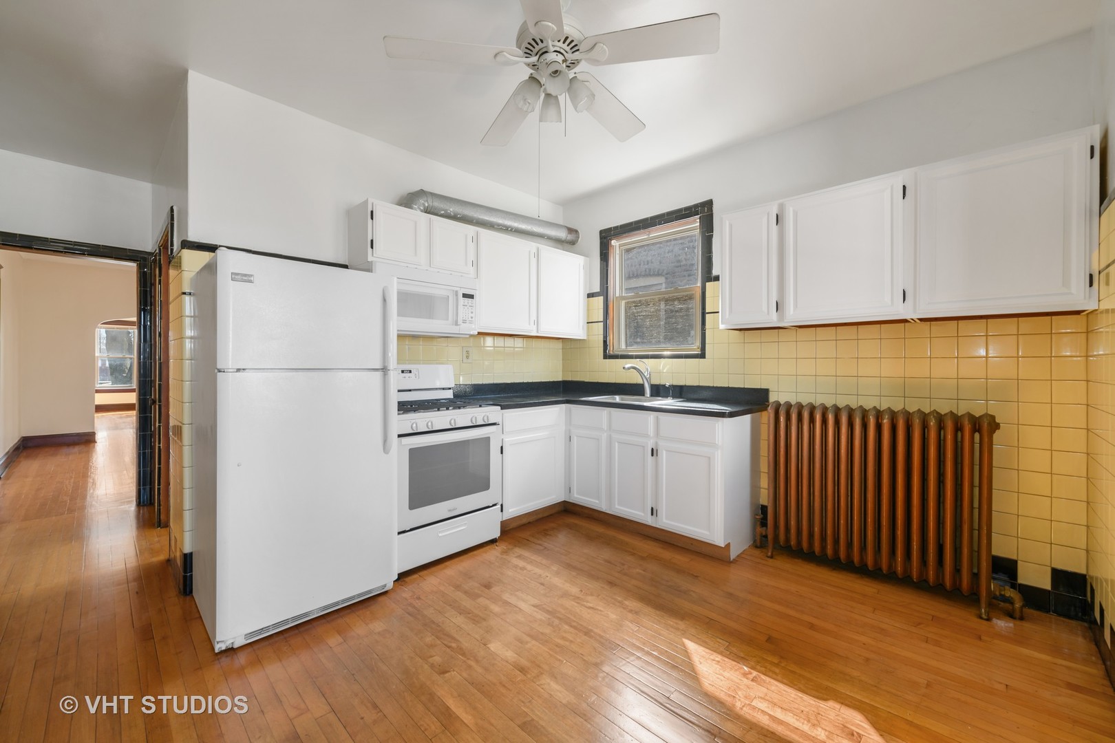 2736 North Harding Avenue, Unit 2 Chicago, IL 60647 - Photo 6 of 12 a kitchen with cabinets stainless steel appliances and wooden floor