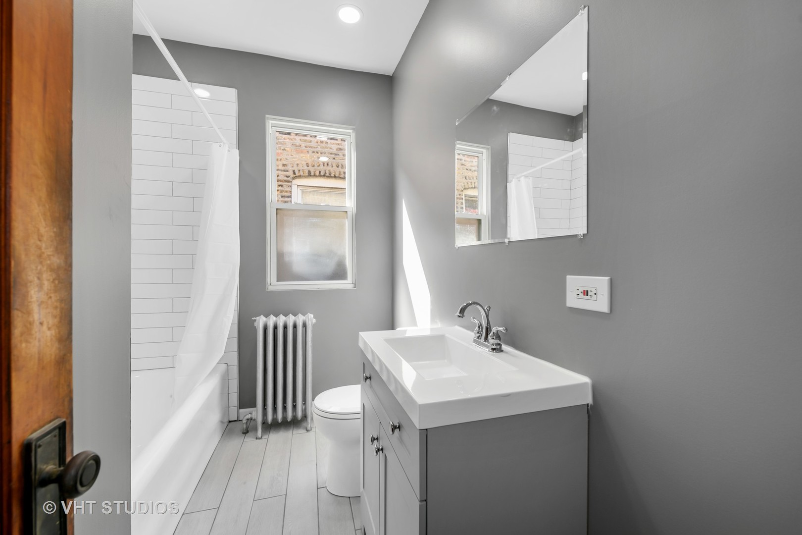 2736 North Harding Avenue, Unit 2 Chicago, IL 60647 - Photo 10 of 12 a bathroom with a sink and a mirror
