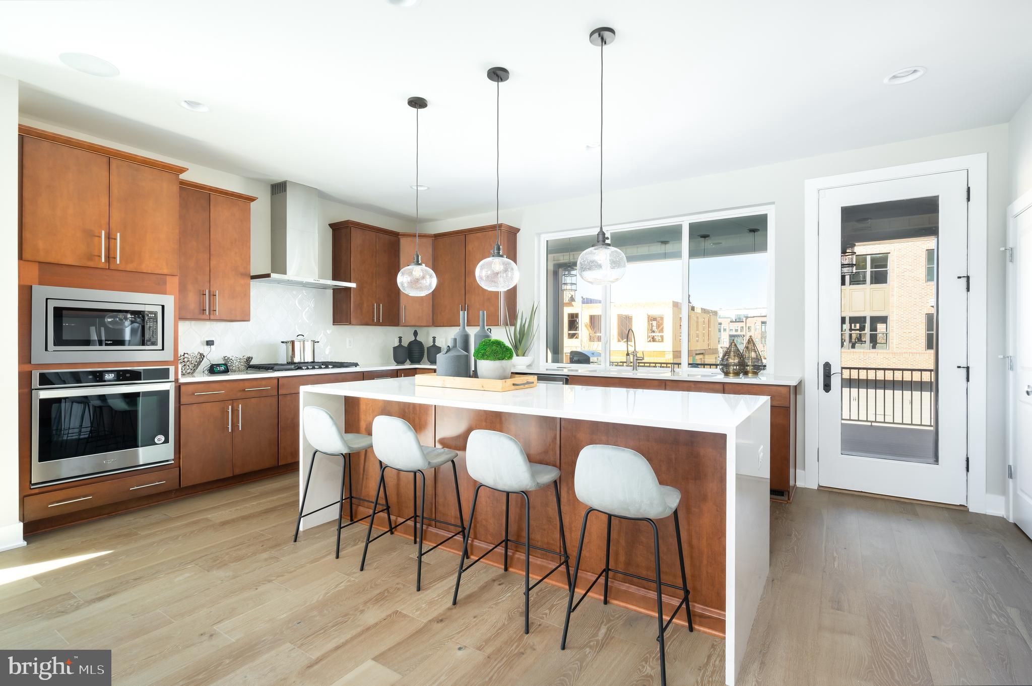 42383 Zenith Terrace Ashburn, VA 20148 - Photo 1 of 29 a kitchen with stainless steel appliances granite countertop wooden floor window and cabinets