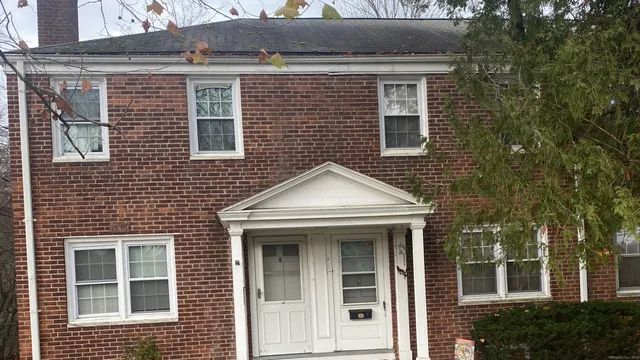 a view of a brick house with large windows