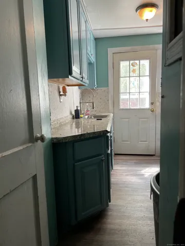 a kitchen with a sink a window and cabinets