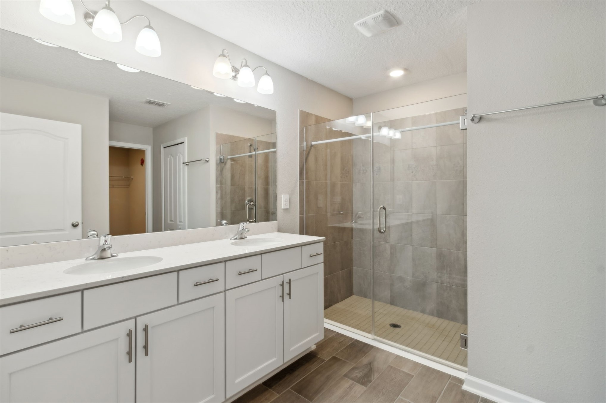 65860 Edgewater Drive Yulee, FL 32097 - Photo 13 of 39 a bathroom with a shower sink double and mirror