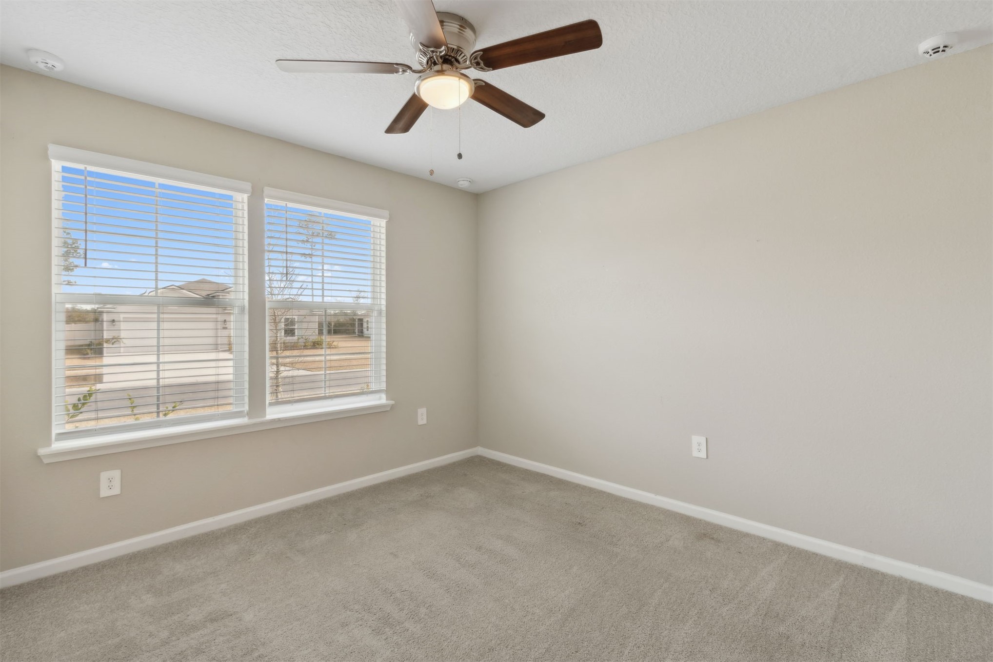 65860 Edgewater Drive Yulee, FL 32097 - Photo 20 of 39 an empty room with a window and a fan