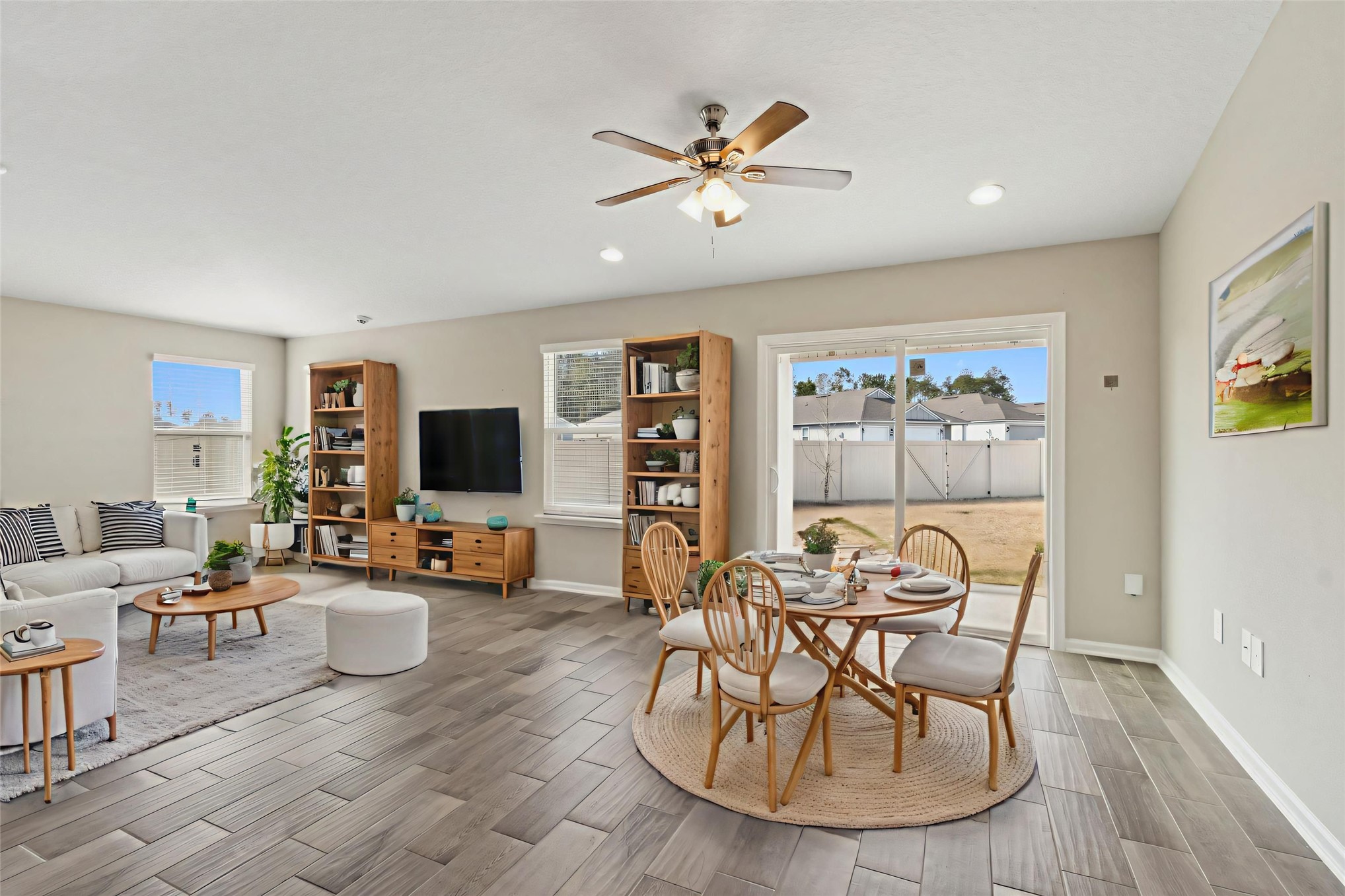 65860 Edgewater Drive Yulee, FL 32097 - Photo 2 of 39 a living room with furniture and a flat screen tv with wooden floor