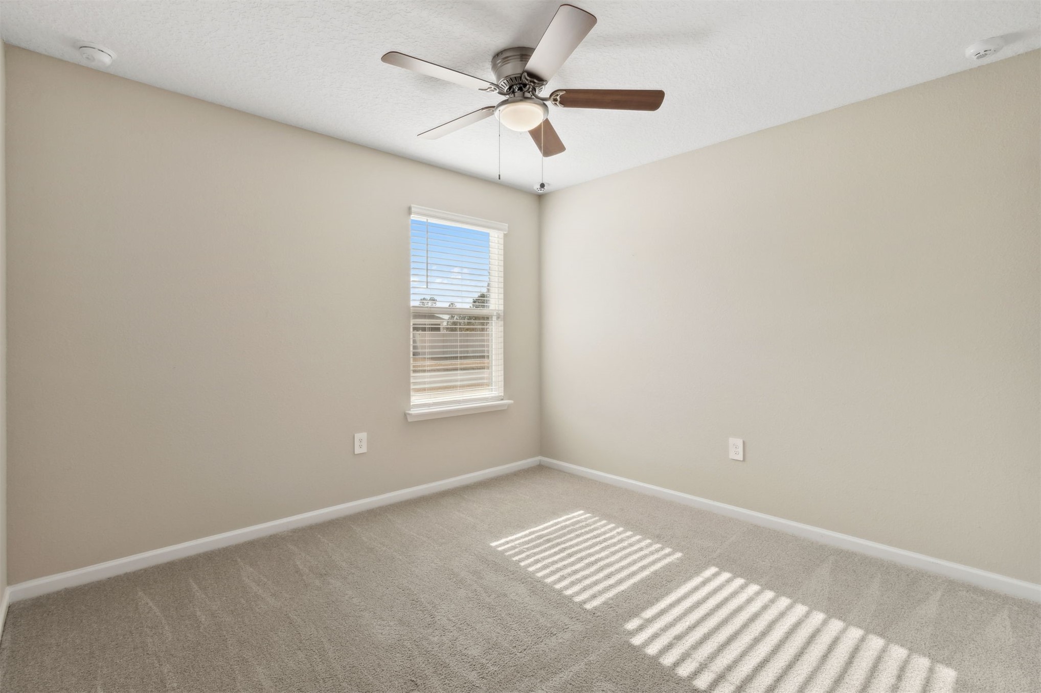 65860 Edgewater Drive Yulee, FL 32097 - Photo 22 of 39 a view of room with a ceiling fan and window
